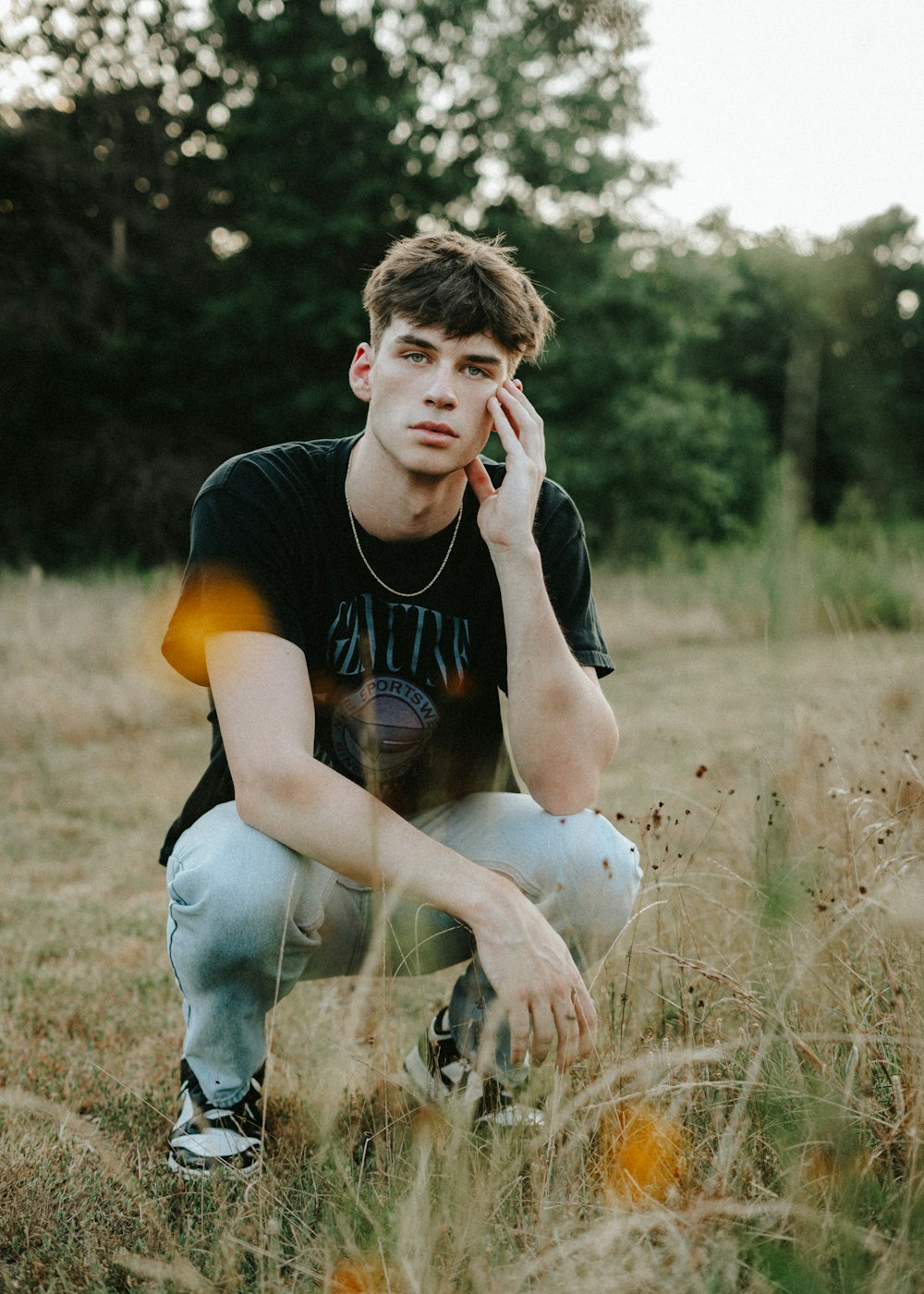 a man sitting in a field