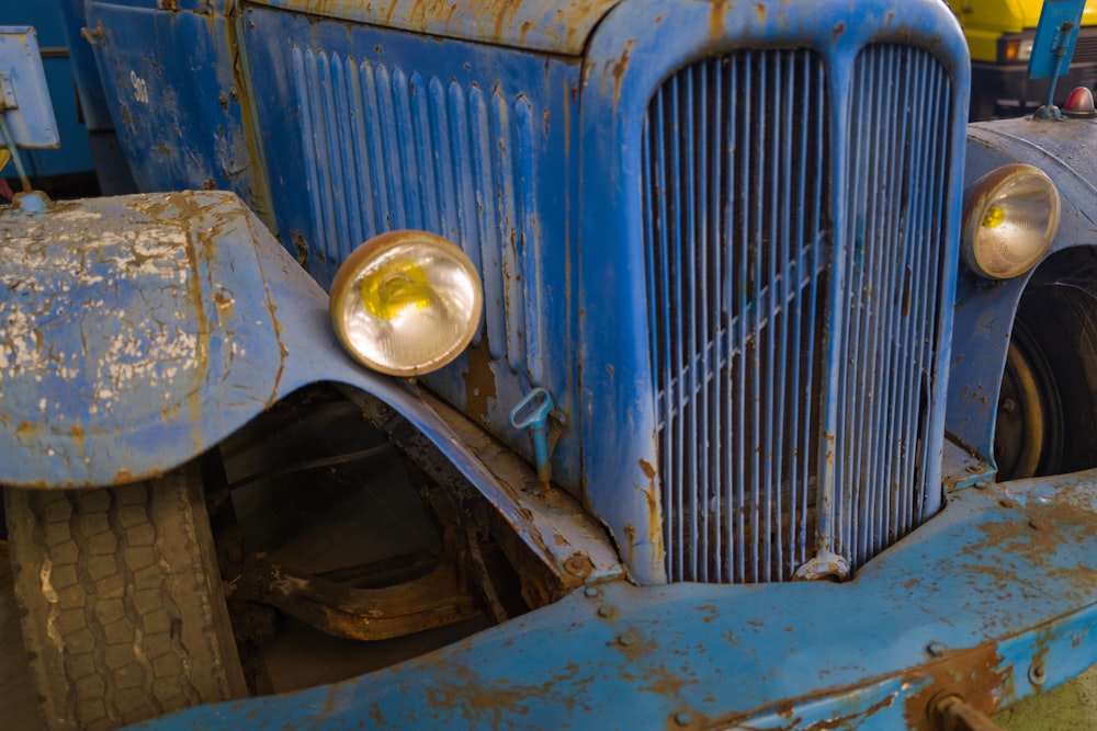 an old blue truck is parked in a garage