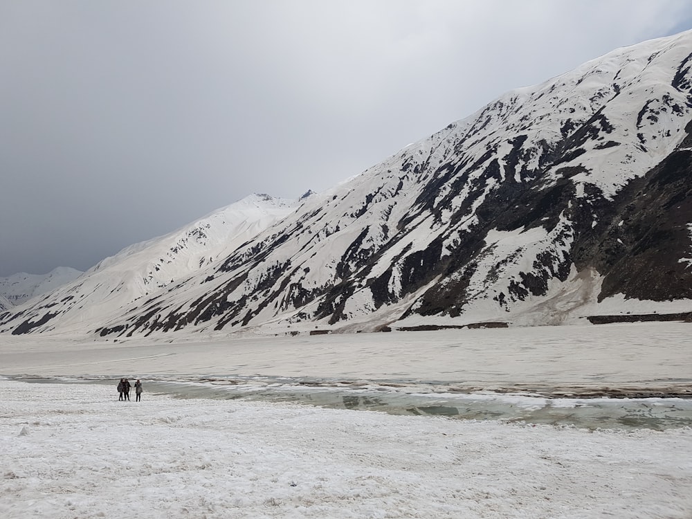 a group of people walking on a snowy mountain