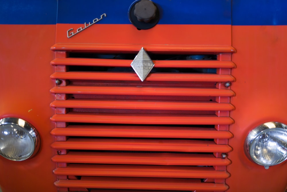 a red rectangular object with silver objects on it