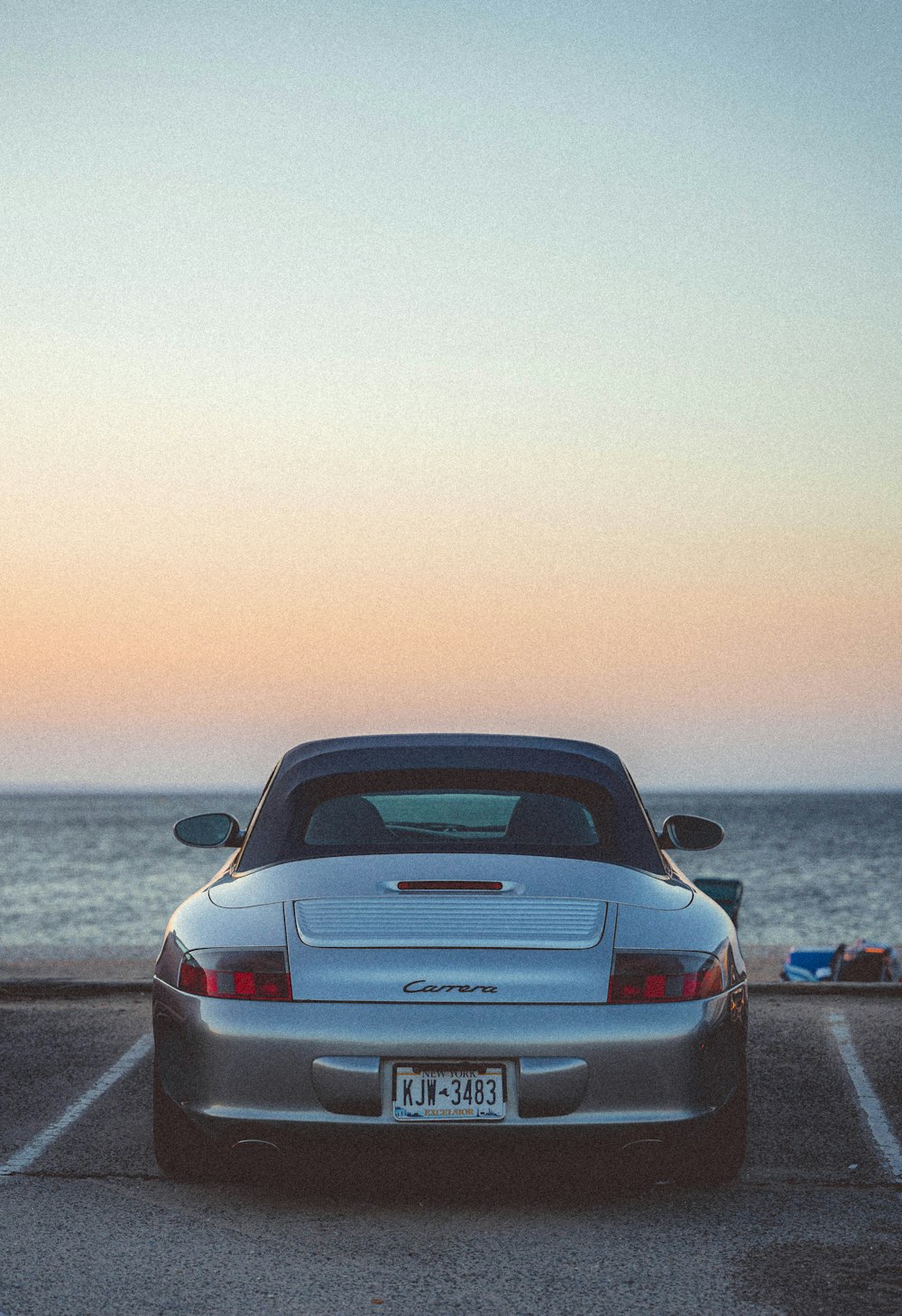 a car parked on a road by the water