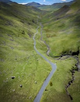 A winding road through a lush green valley.