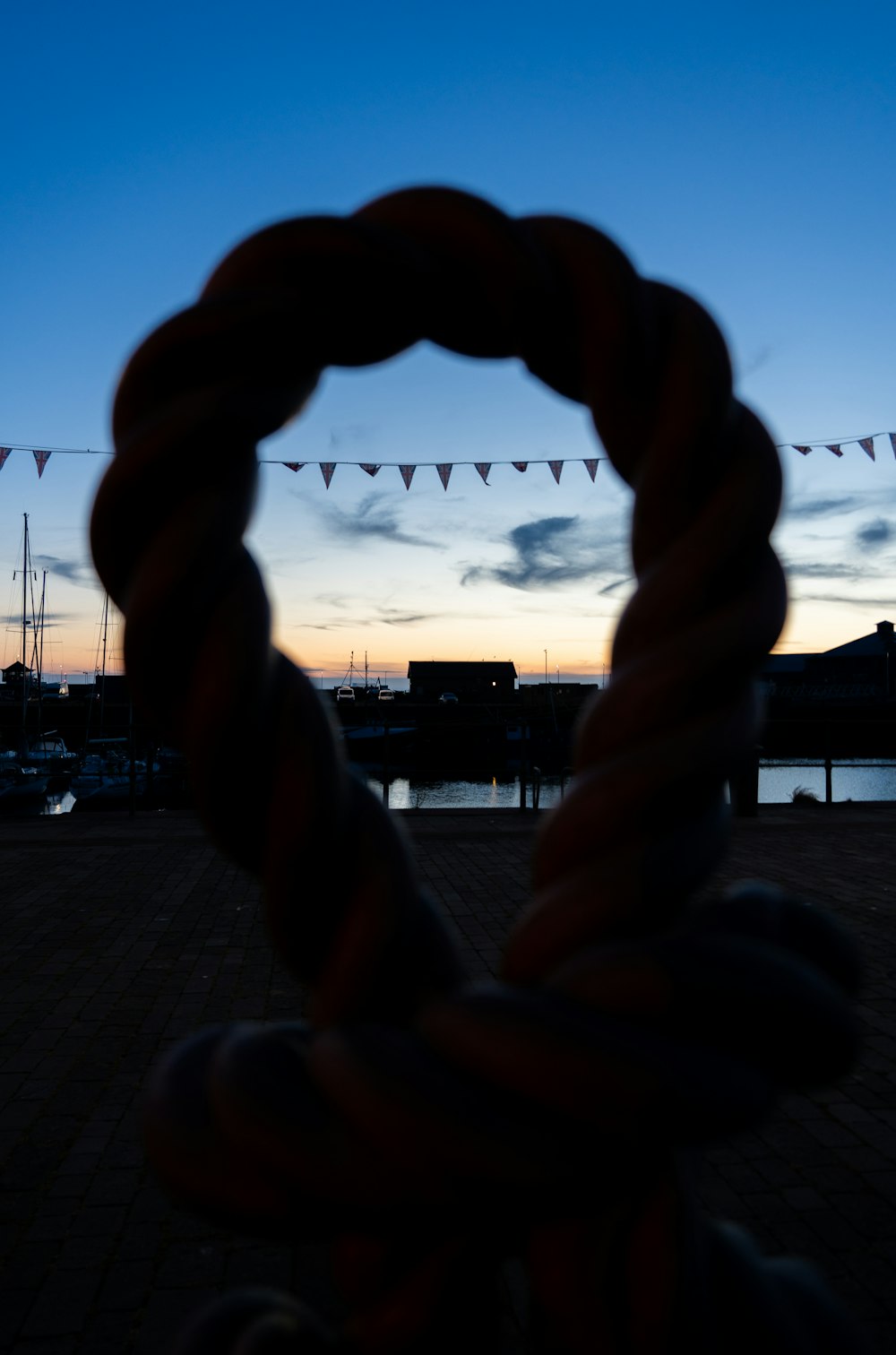 a person's hand with a sunset in the background