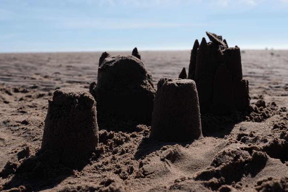 a group of rocks in the sand