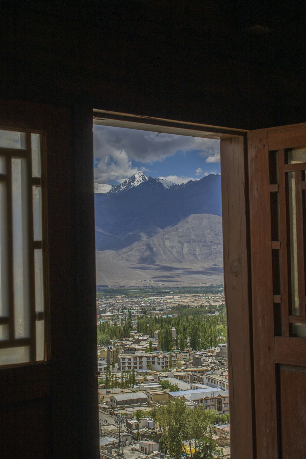 a view of a mountain and a city from a window