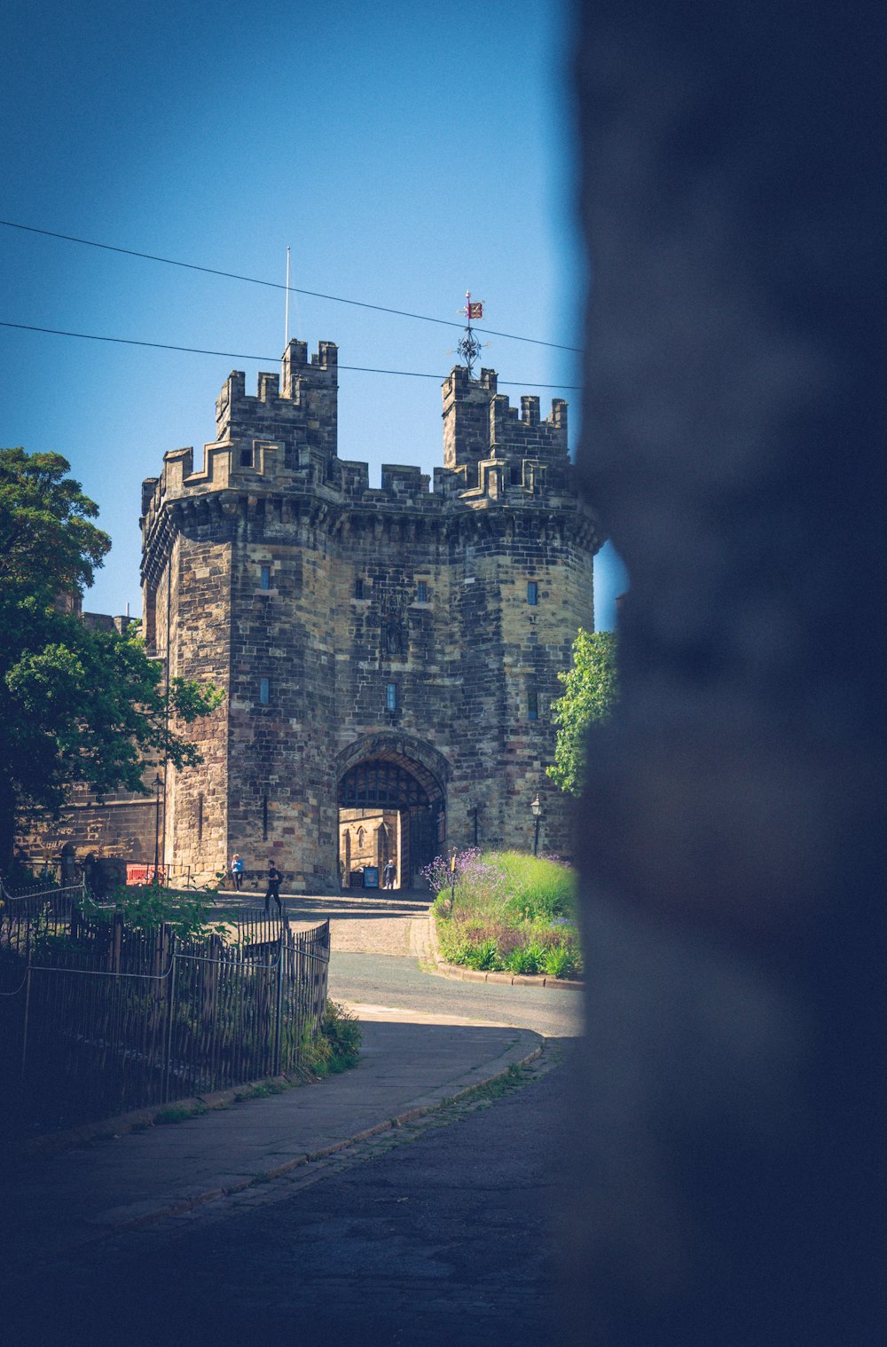 a castle with a walkway and a road