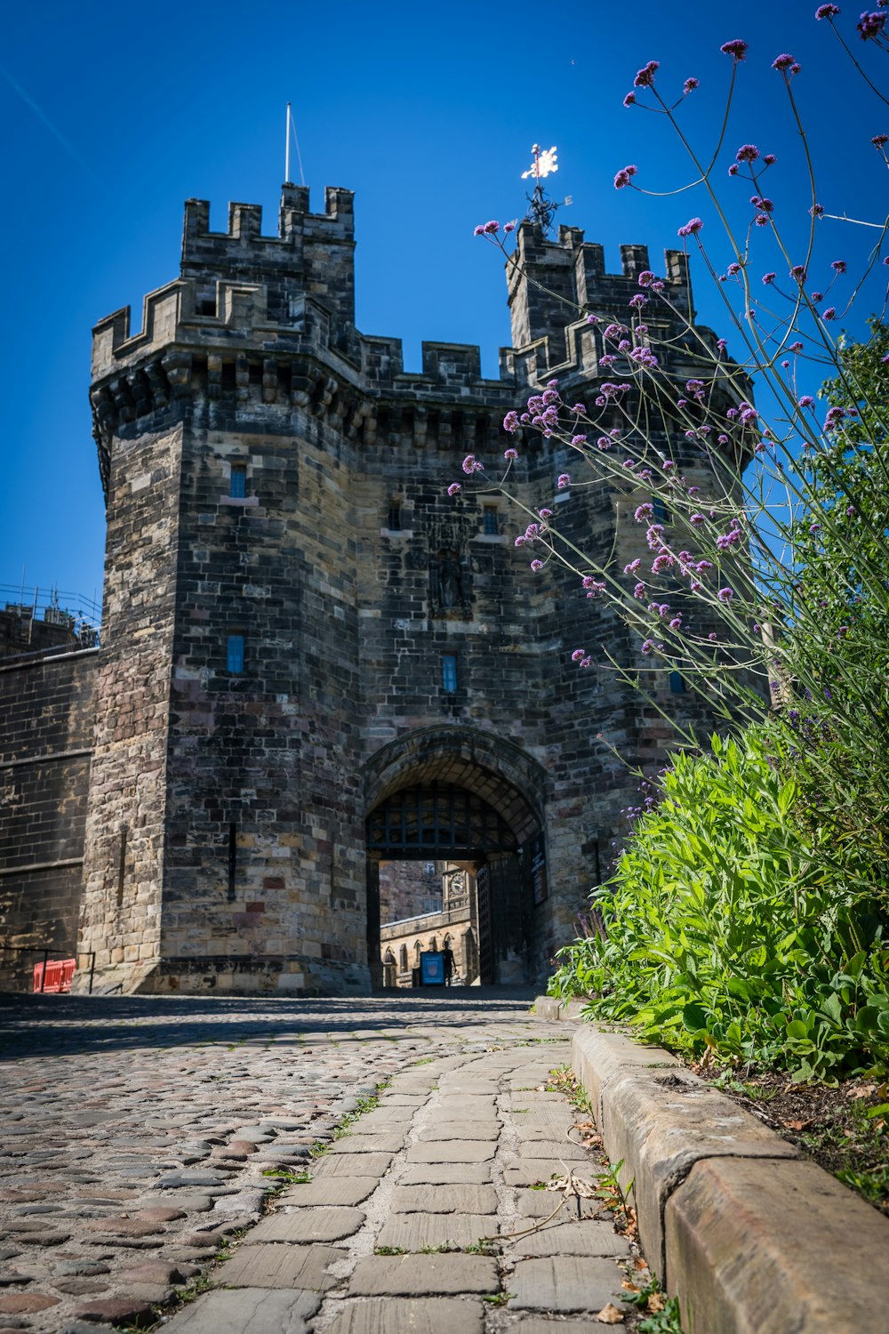 a stone castle with a walkway