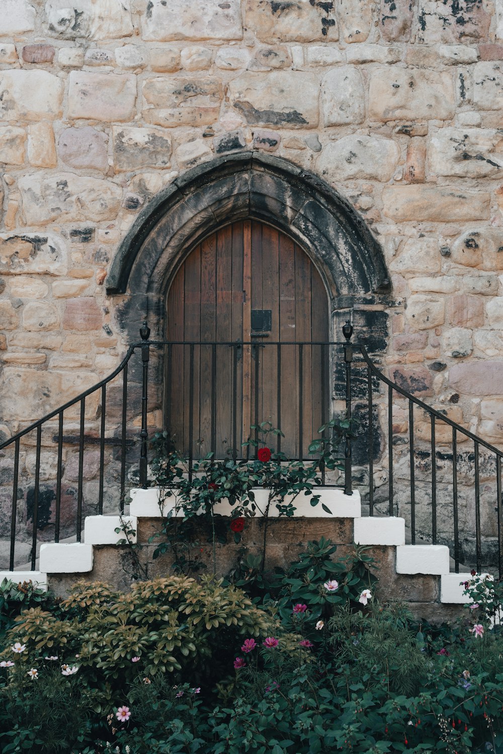 a gate in front of a stone building