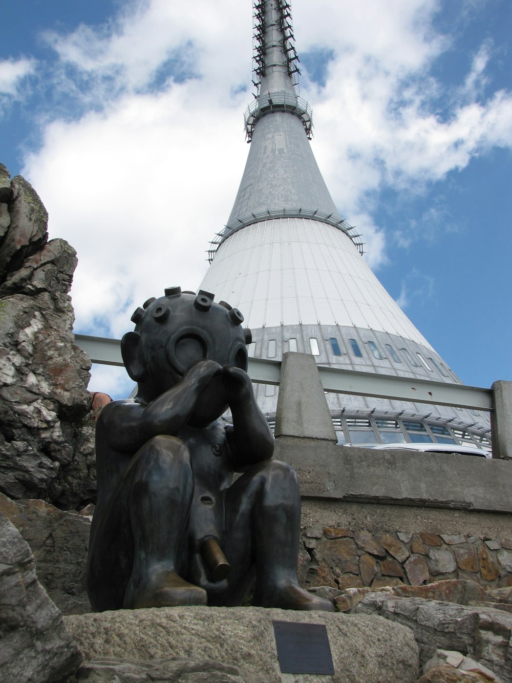 a statue of a person with a building in the background