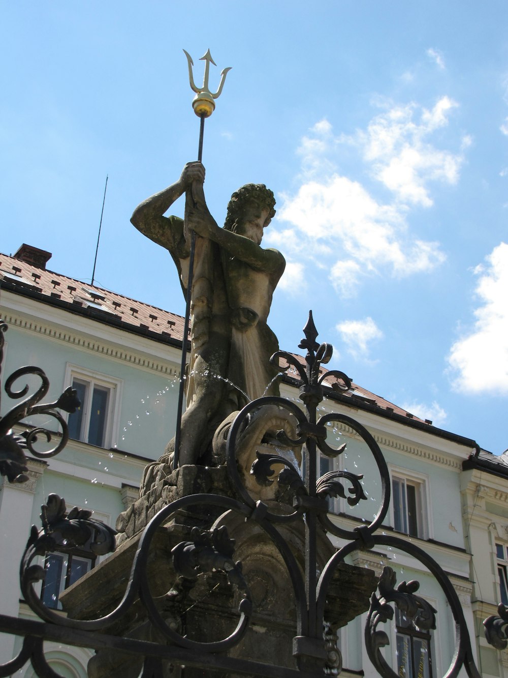 a statue of a person holding a cross on a building