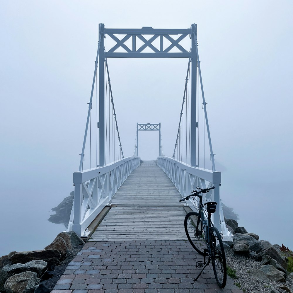a bicycle parked on a bridge