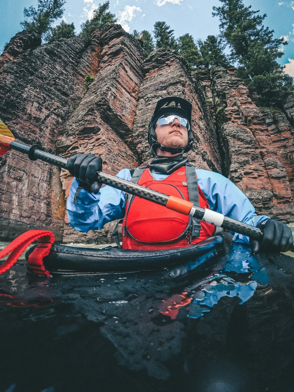 a man in a kayak in a river