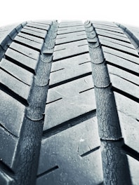 A close-up of a certified winter tire showcasing its tread pattern.