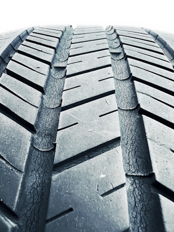 A detailed view of a motorcycle tire with tread patterns.