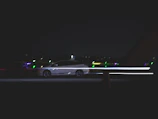 Dynamic Škoda Octavia RS captured in motion on a dark road with subtle light trails.