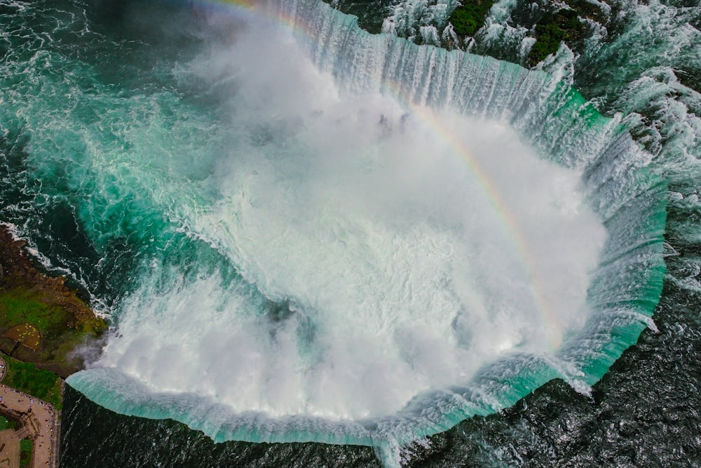 a large waterfall with a rainbow