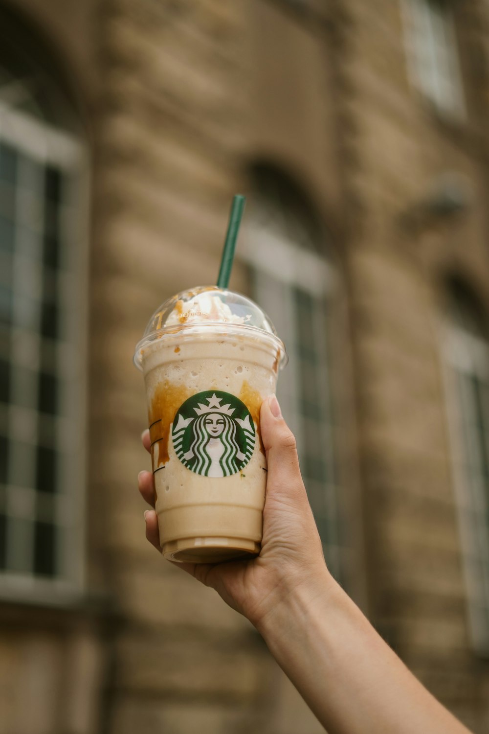 a hand holding a cup of coffee