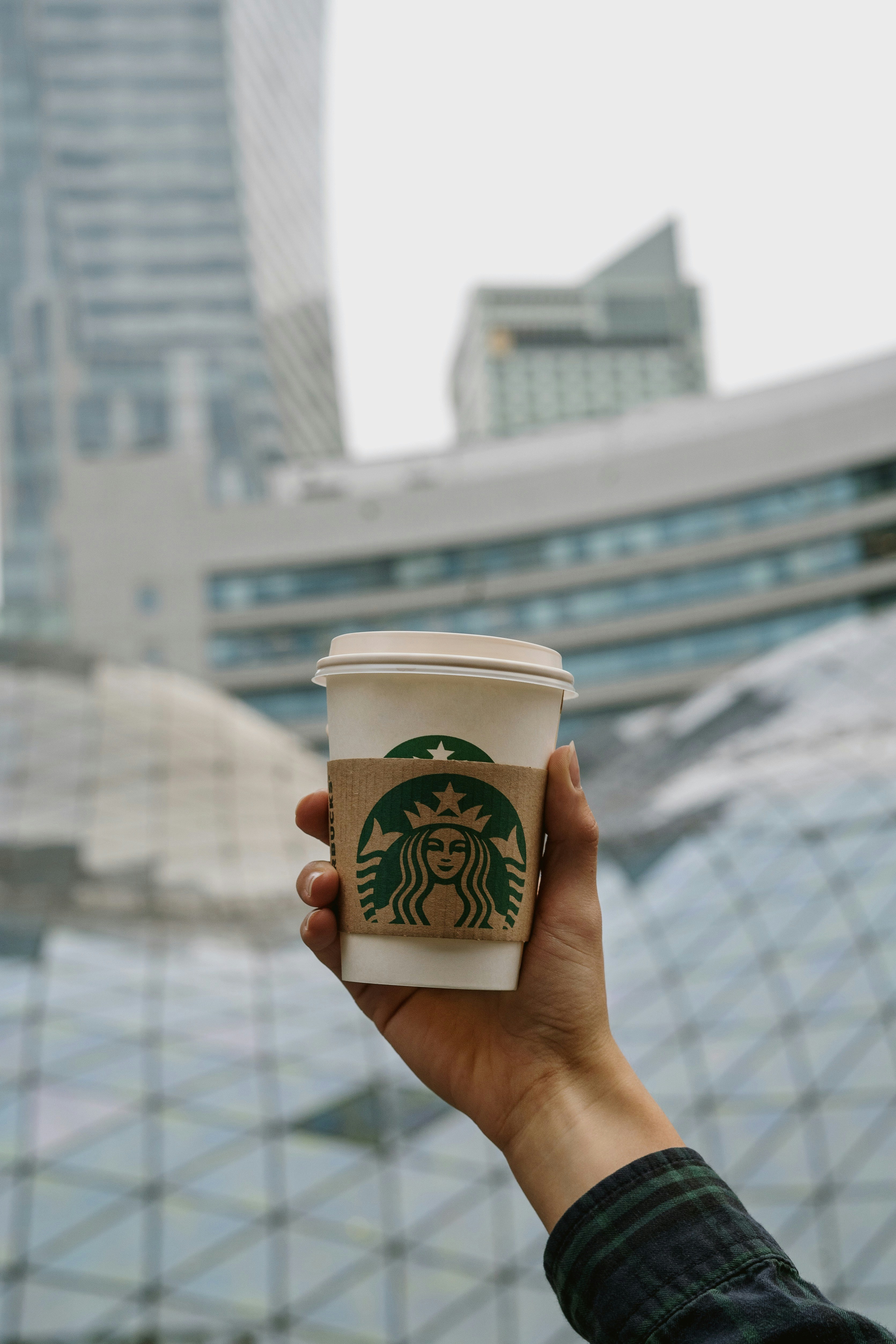 a hand holding a cup of coffee