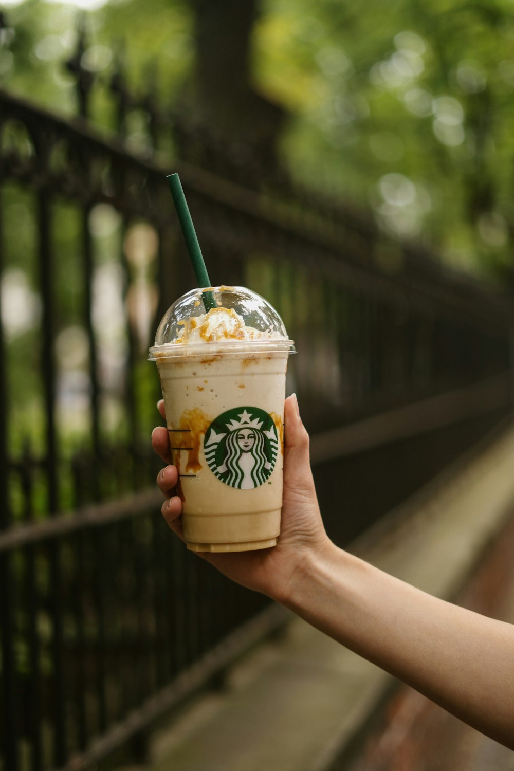 a hand holding a cup of coffee