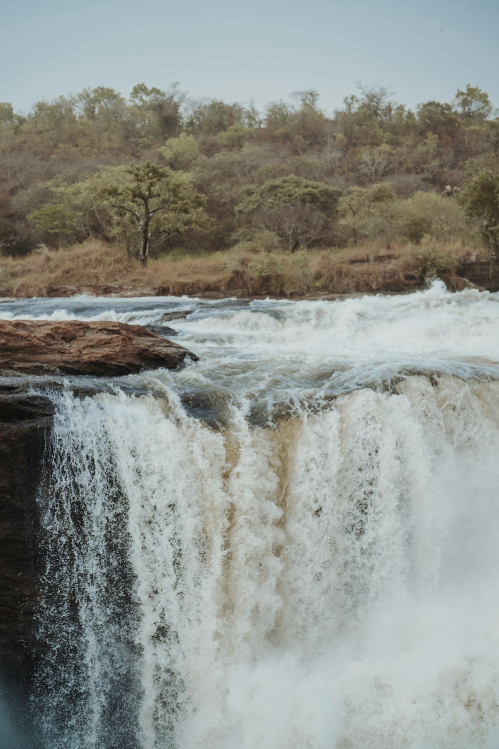 a waterfall with trees in the background