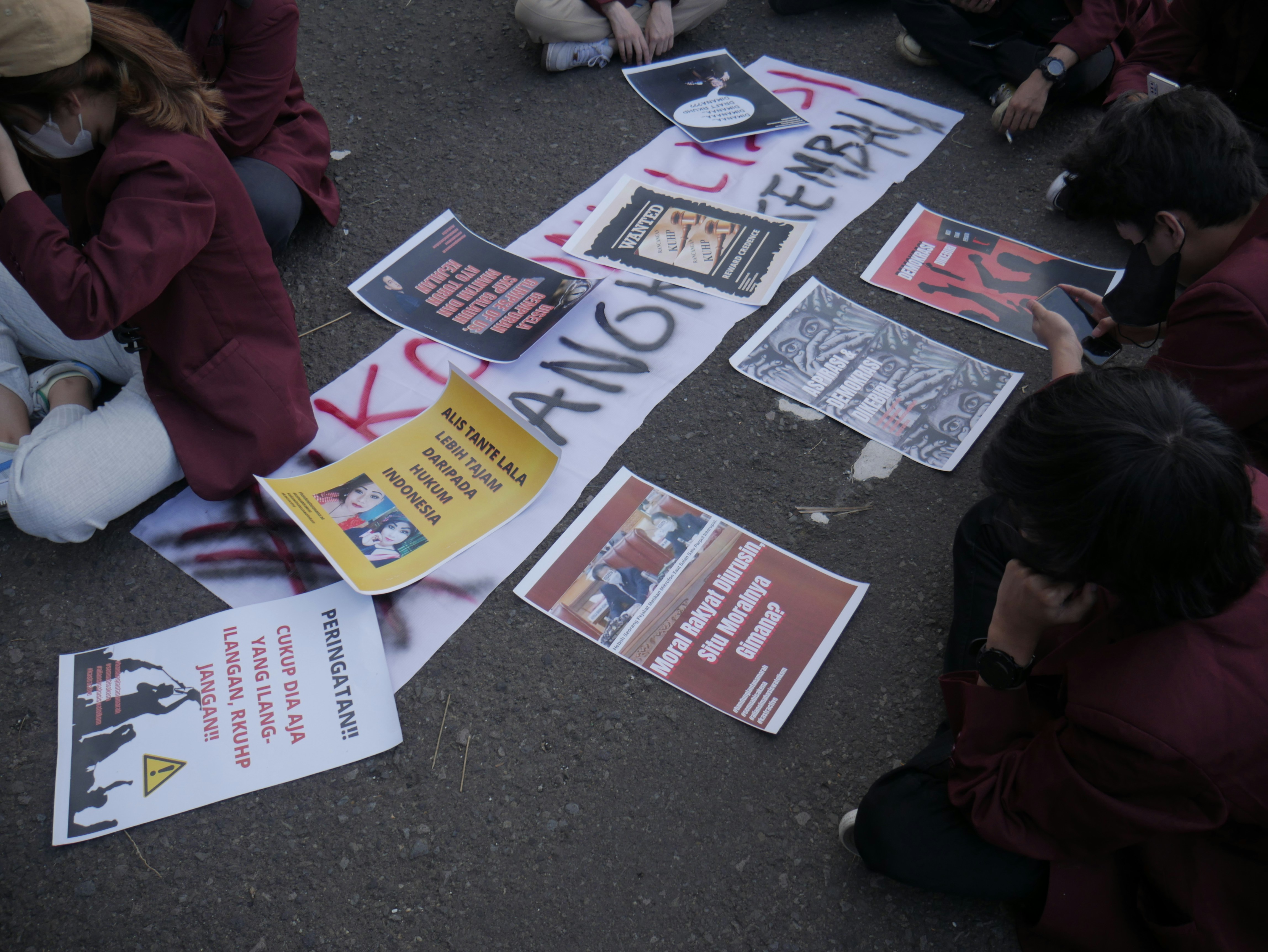 a group of people sitting on the floor reading books
