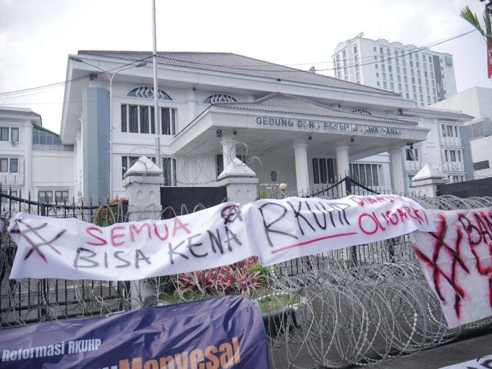 a white building with a banner in front of it