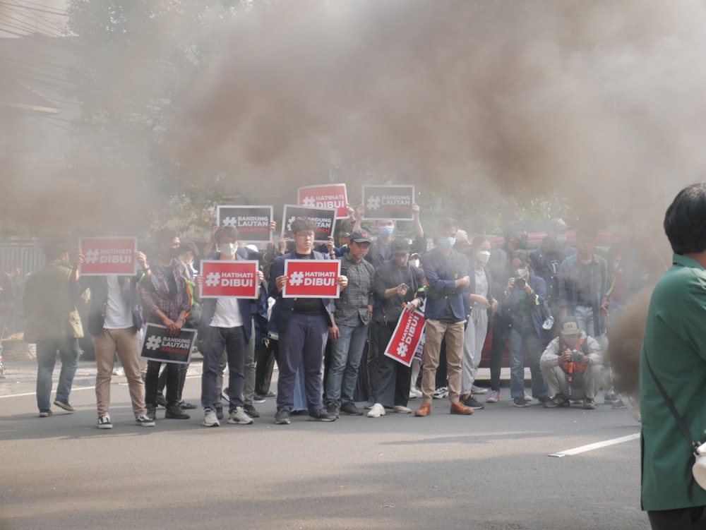 a group of people holding signs