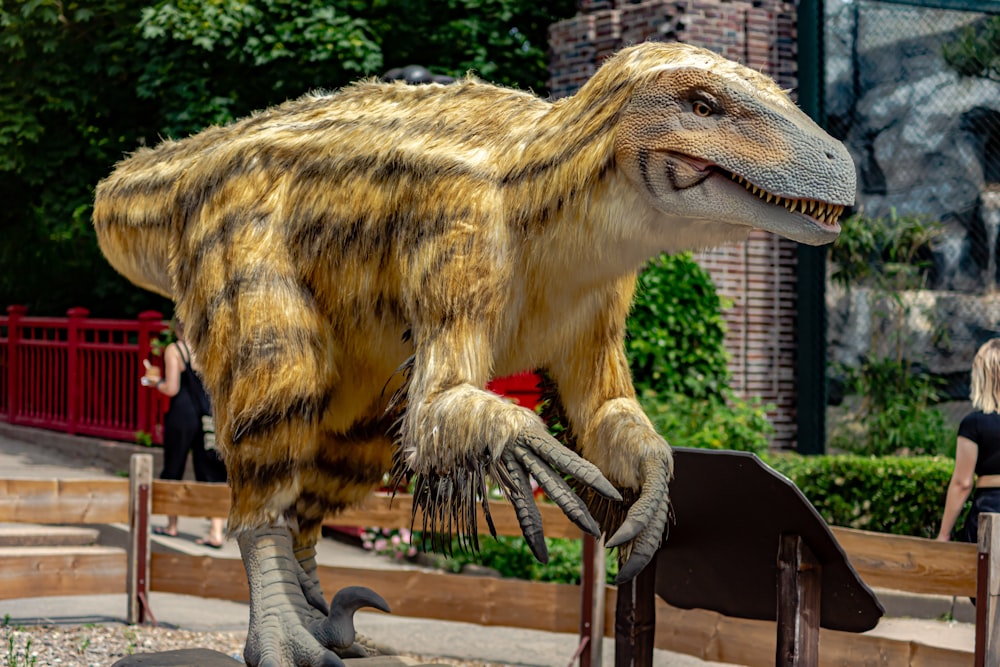 a dinosaur statue on a wooden platform