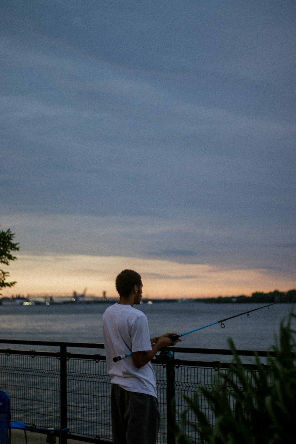 a man fishing on a railing