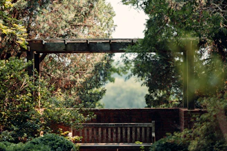 A serene backyard scene with a stylish pergola shade casting gentle shadows over a cozy seating area.