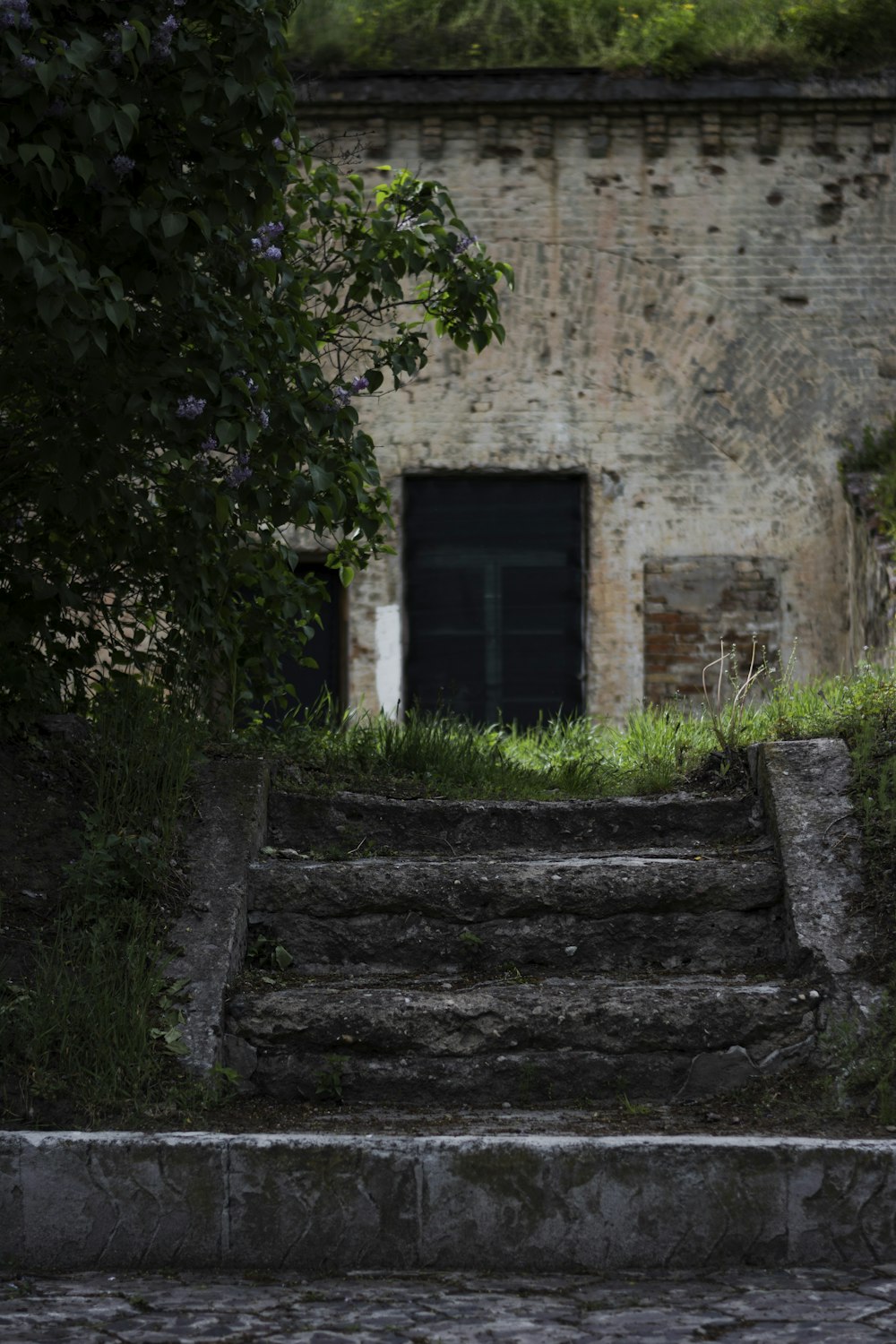 a stone building with a door and stairs