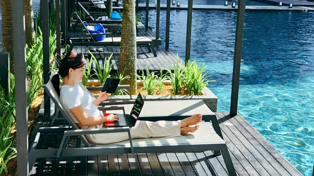 a person sitting on a bench with a laptop