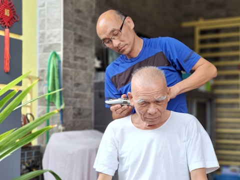 Volunteers providing free haircuts to elderly community members in a cozy community center.