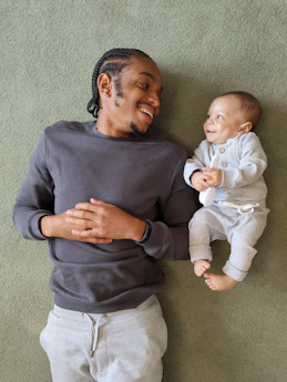 Father and baby looking at each other and smiling