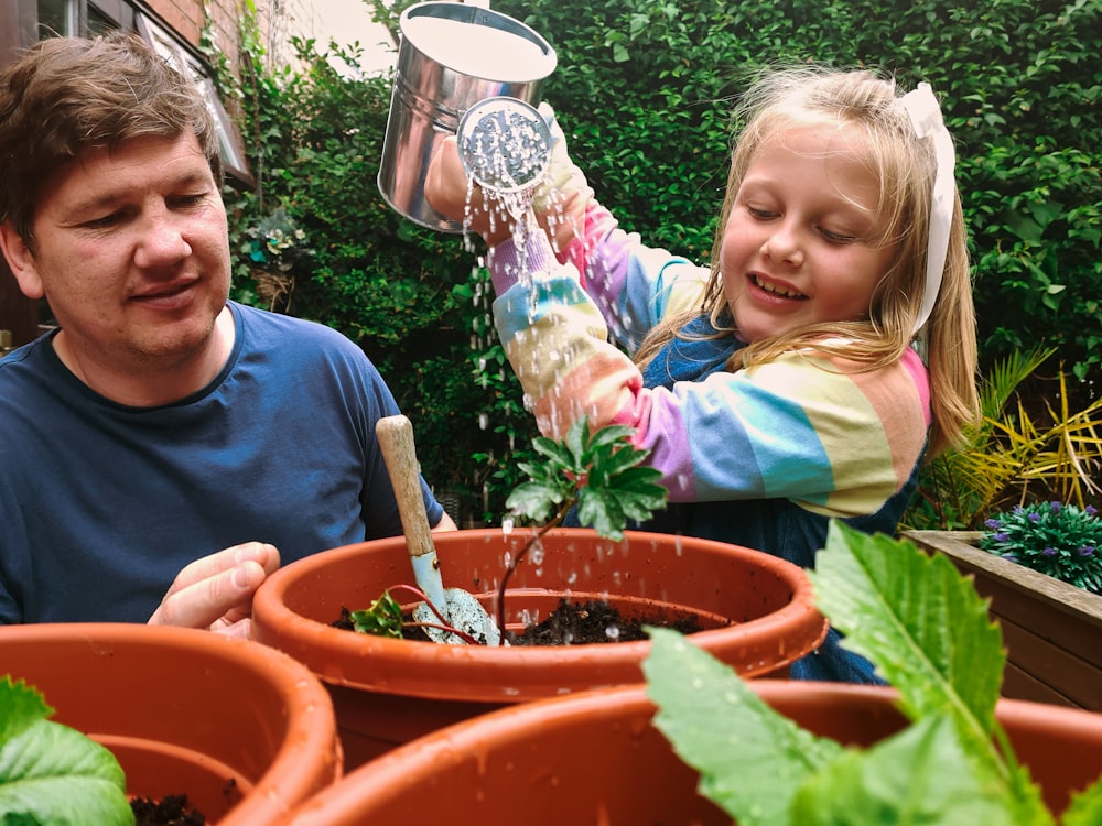 a person and a girl in a garden