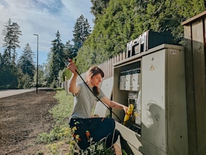 Pacific Palisades Electrician pulling wire at an Electrical panel.