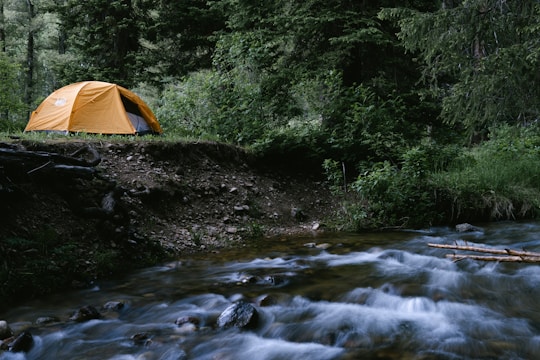 a tent on a rocky river