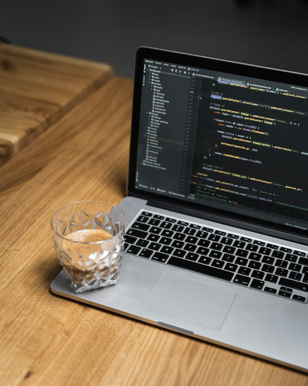 a laptop with a glass of liquid on the screen