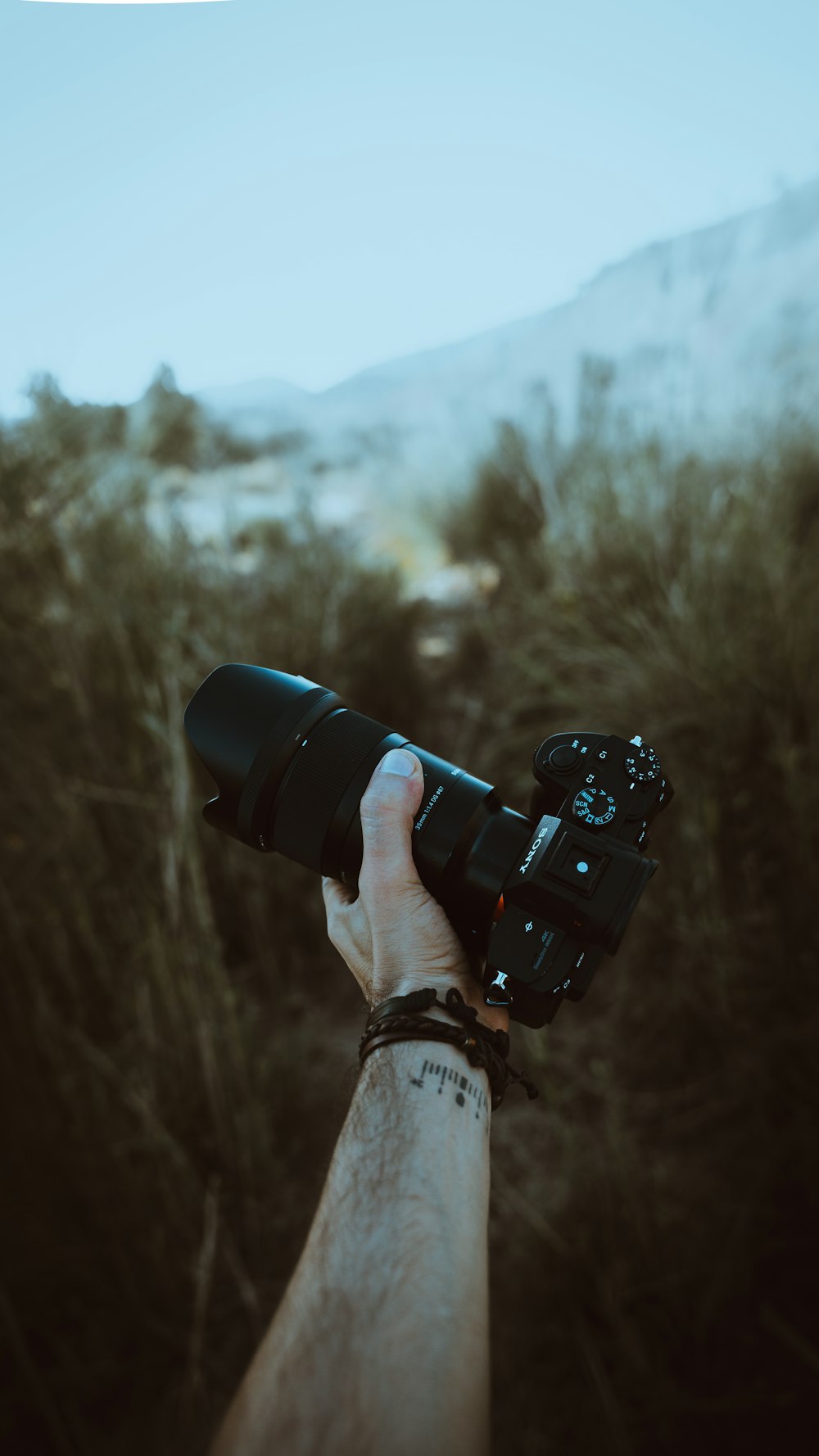 a hand holding a camera
