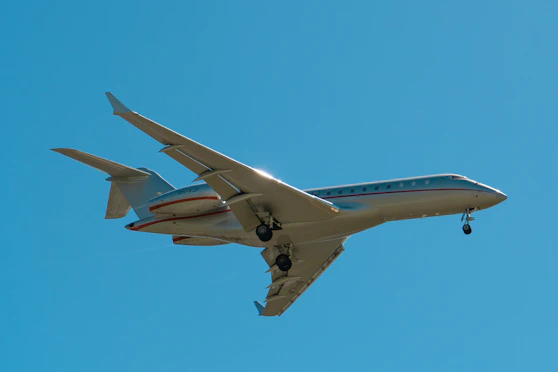 A sleek private jet ready for takeoff on a clear runway during sunset.