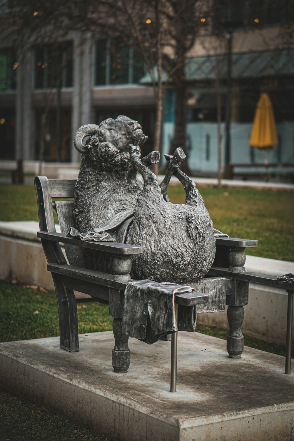 a statue of a bear sitting on a bench