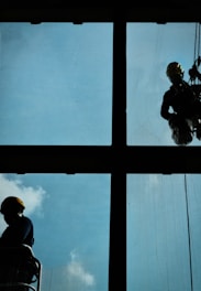 a man and woman looking out a window