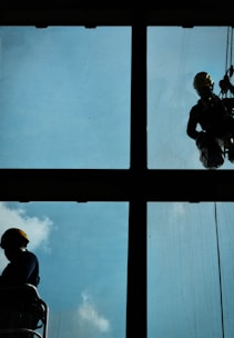 a man and woman looking out a window