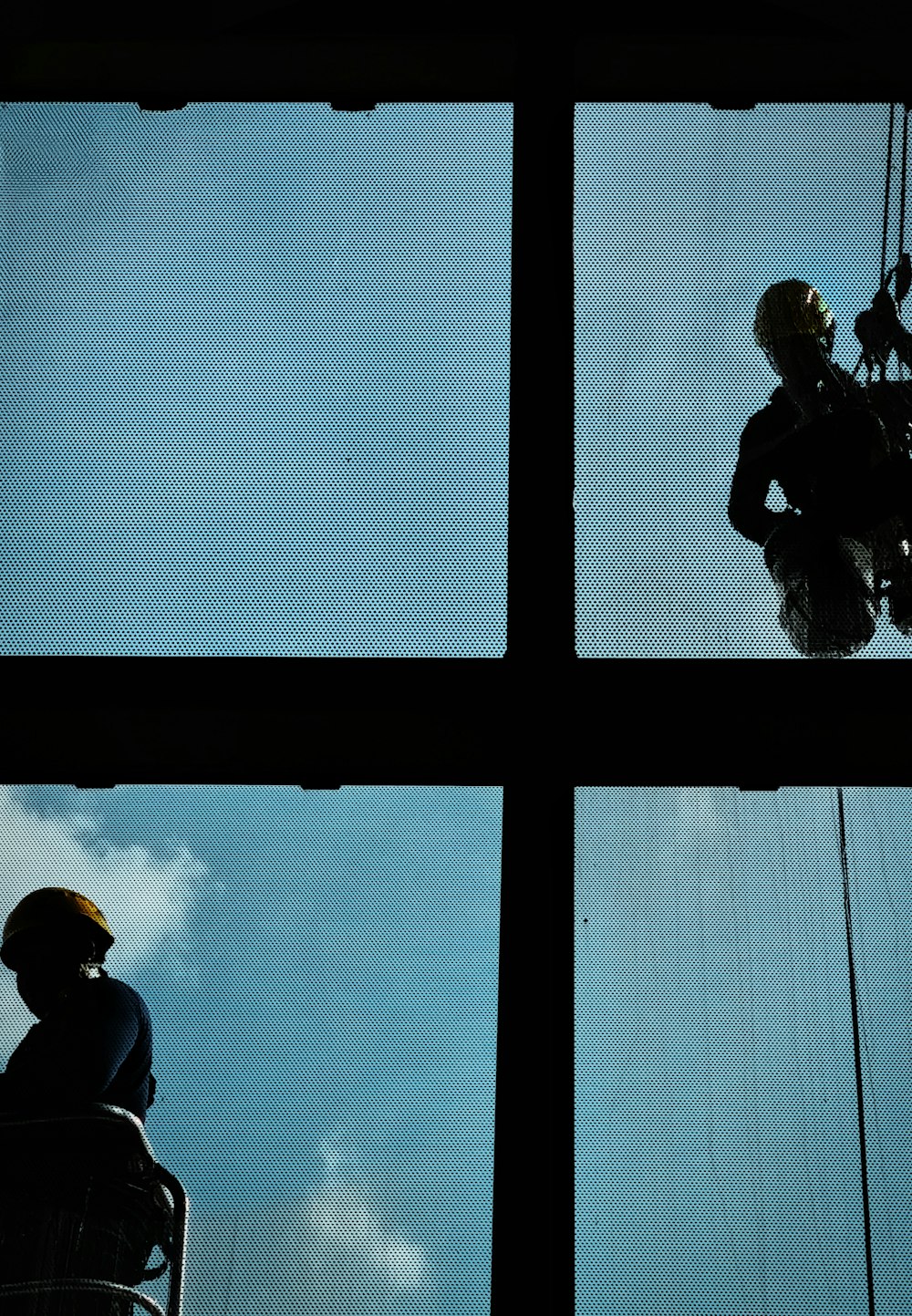 a man and woman looking out a window