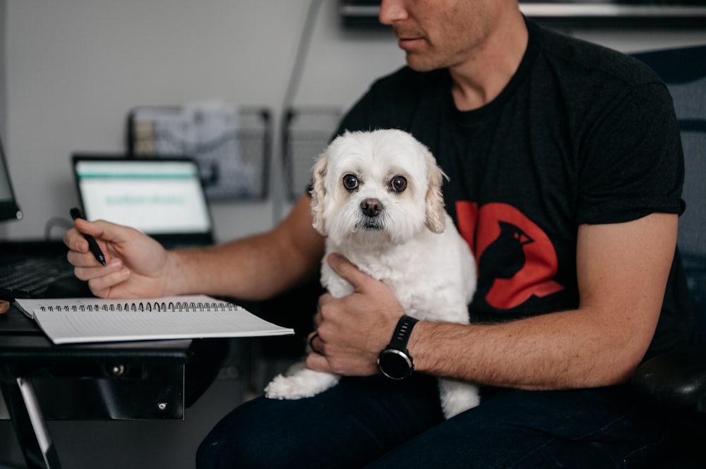 a man holding a dog