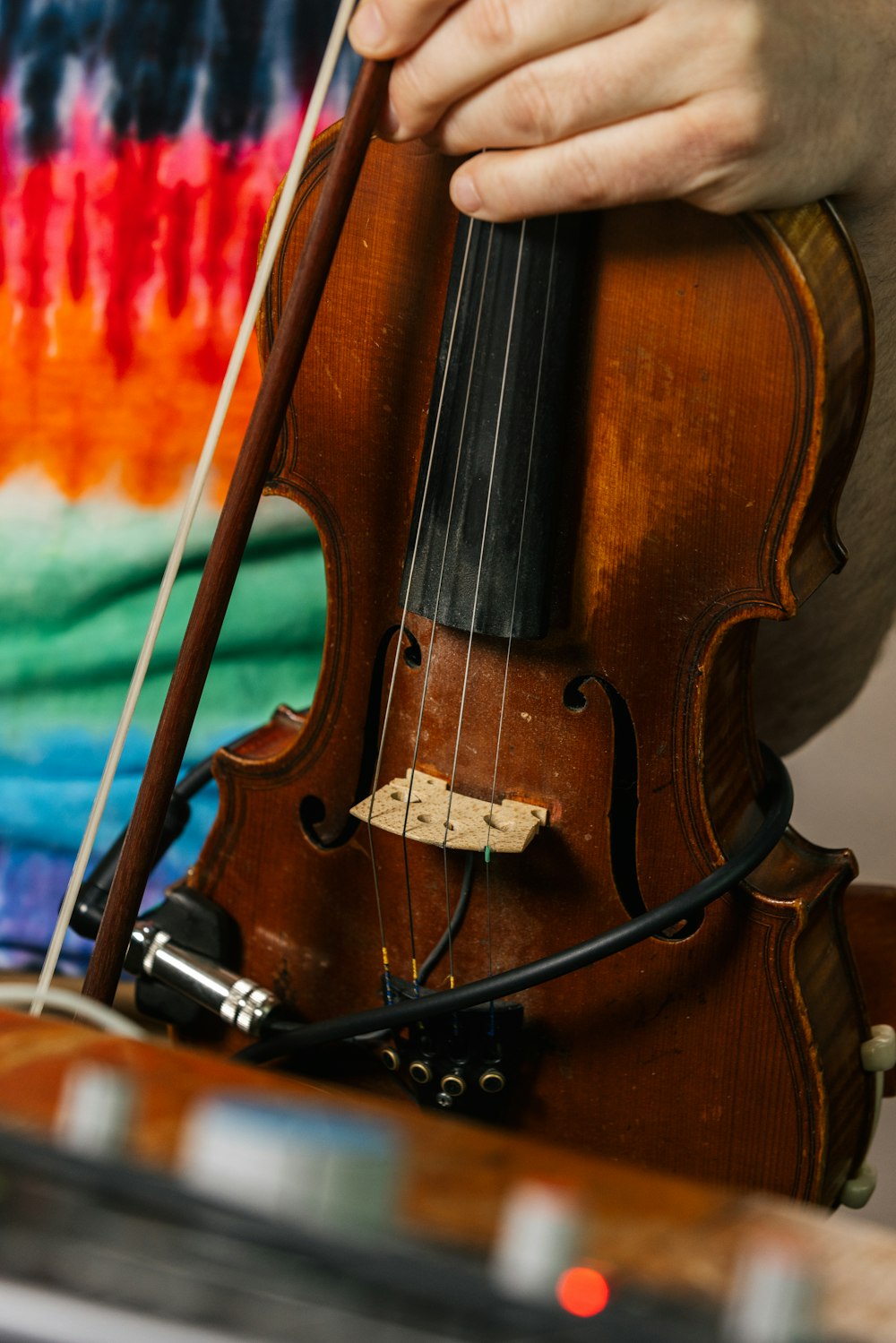 a hand holding a cello