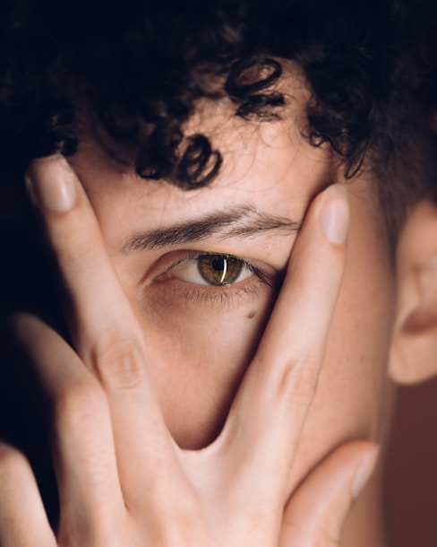 a person with the hand on the face