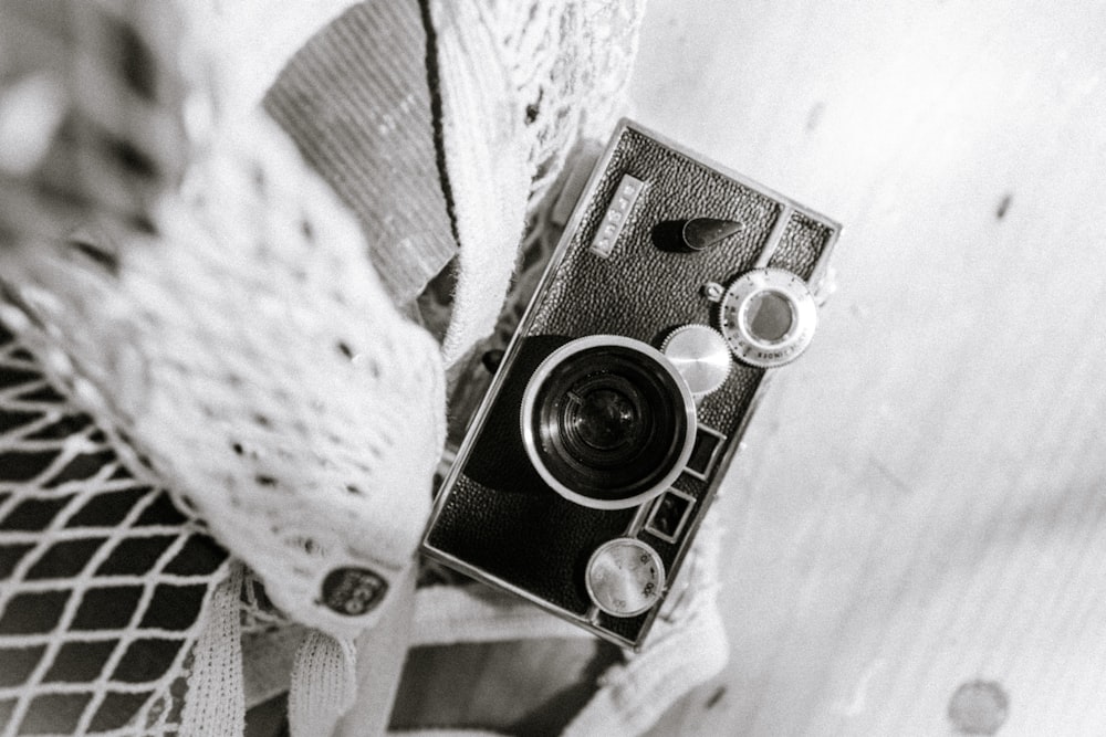 a black and white photo of a camera on a piece of fabric
