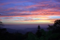 A vibrant sunrise over a hill, capturing hope and renewal.