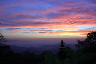 A vibrant sunrise over a natural landscape, representing hope and new beginnings for indigenous communities.